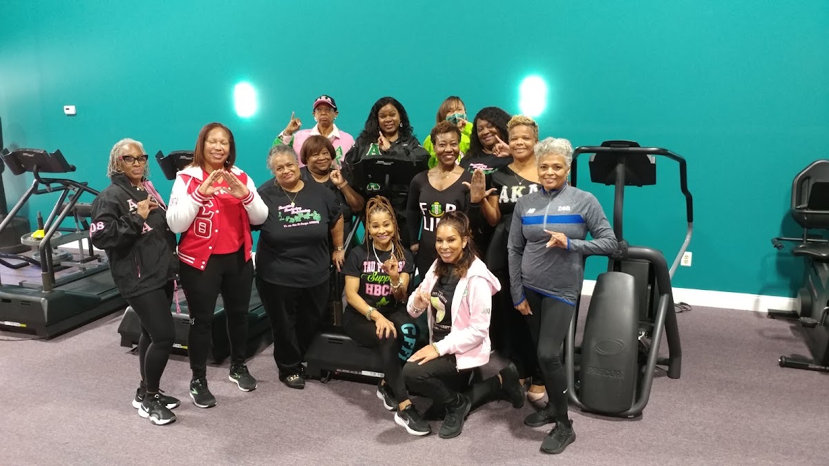 A lively group class celebrating together at Carla Fields Fitness
